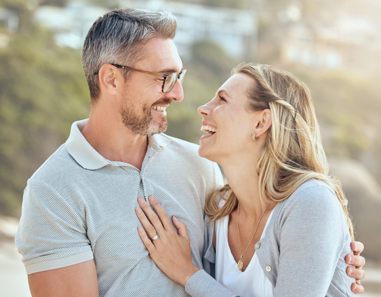 Happy and loving mature caucasian couple enjoying a romantic date at the beach together on a sunny .